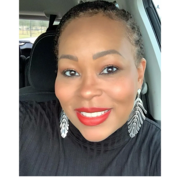 Smiling woman with red lipstick and statement earrings in a car.