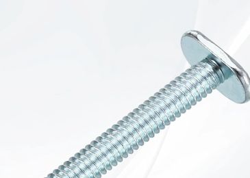 Close-up of a shiny metal bolt with threading.