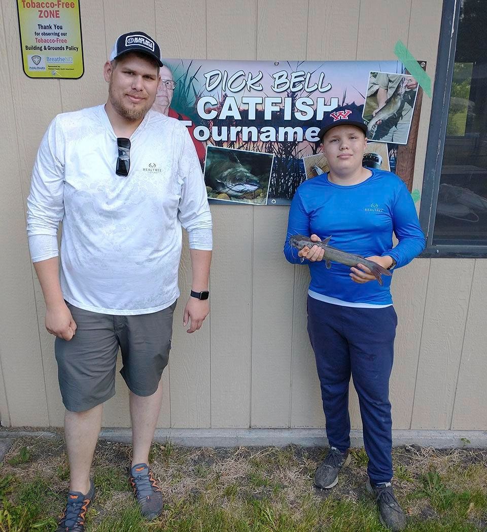 Justin Kratz, chair of the Dick Bell Catfish Tournament committee, with youth category winner Delvin Bigwood. The tournament was held Saturday, June 4 on the Red and Bois de Sioux rivers.