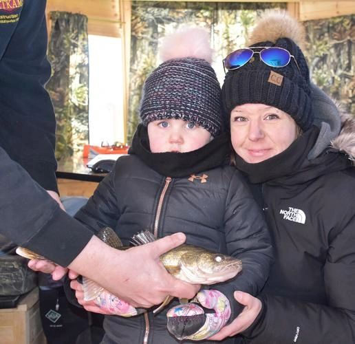 This year’s anglers included Westyn Helfenstein, 3, Foxhome, Minn., who came in first for the walleye and largest fish categories. Pictured are Helfenstein, Lyle, a 16.5-inch walleye named by Helfenstein, and her mom, Alisha. This year’s anglers included Westyn Helfenstein, 3, Foxhome, Minn., who came in first for the walleye and largest fish categories. Pictured are Helfenstein, Lyle, a 16.5-inch walleye named by Helfenstein, and her mom, Alisha.