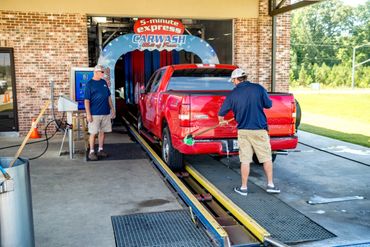 A Red Car Being Washed In A Wash