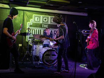 Image of a TMP College band performing at The Boulevard in Wigan Town Centre. 