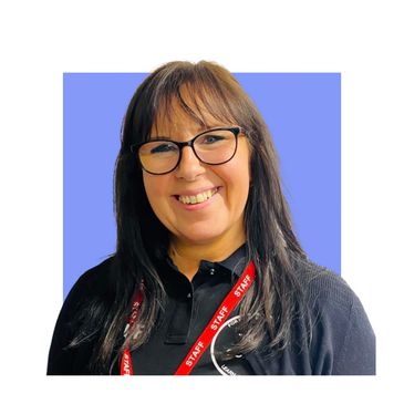 Smiling woman with glasses wearing a staff lanyard.