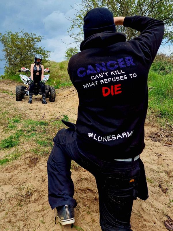 Behind scenes photo on a sand dune near a beach in Mablethorpe, Lincolnshire. the woman is on a quad