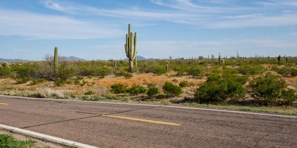 Two-lane road through desert landscape.