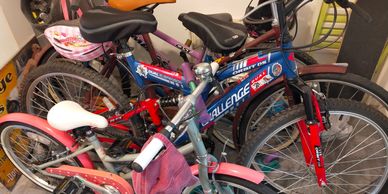 A cluster of colorful bicycles parked indoors.