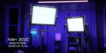 Two Alien 300C LED lights glowing in a dark room.