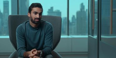 Man sitting and talking in a modern office.
