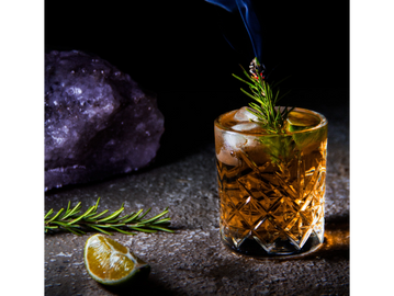 bourbon drink in glass on the rocks with smoke 