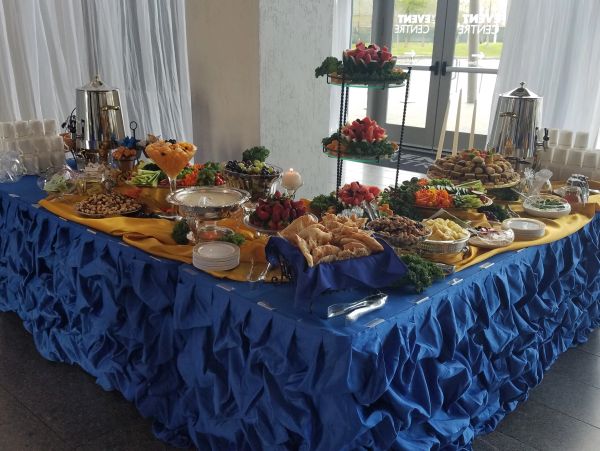 Elegant buffet table with a variety of appetizers and desserts.
