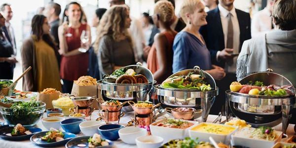 Buffet table with diverse dishes at a social gathering.