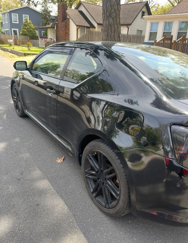 Black sedan parked on a residential street.