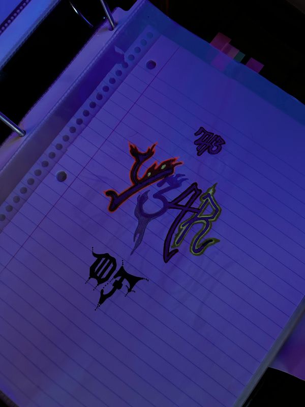 Artistic graffiti-style lettering on lined notebook paper in a binder.