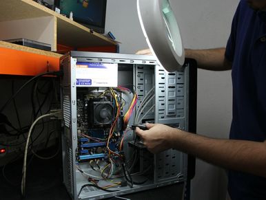 A technician troubleshoots a desktop computer
