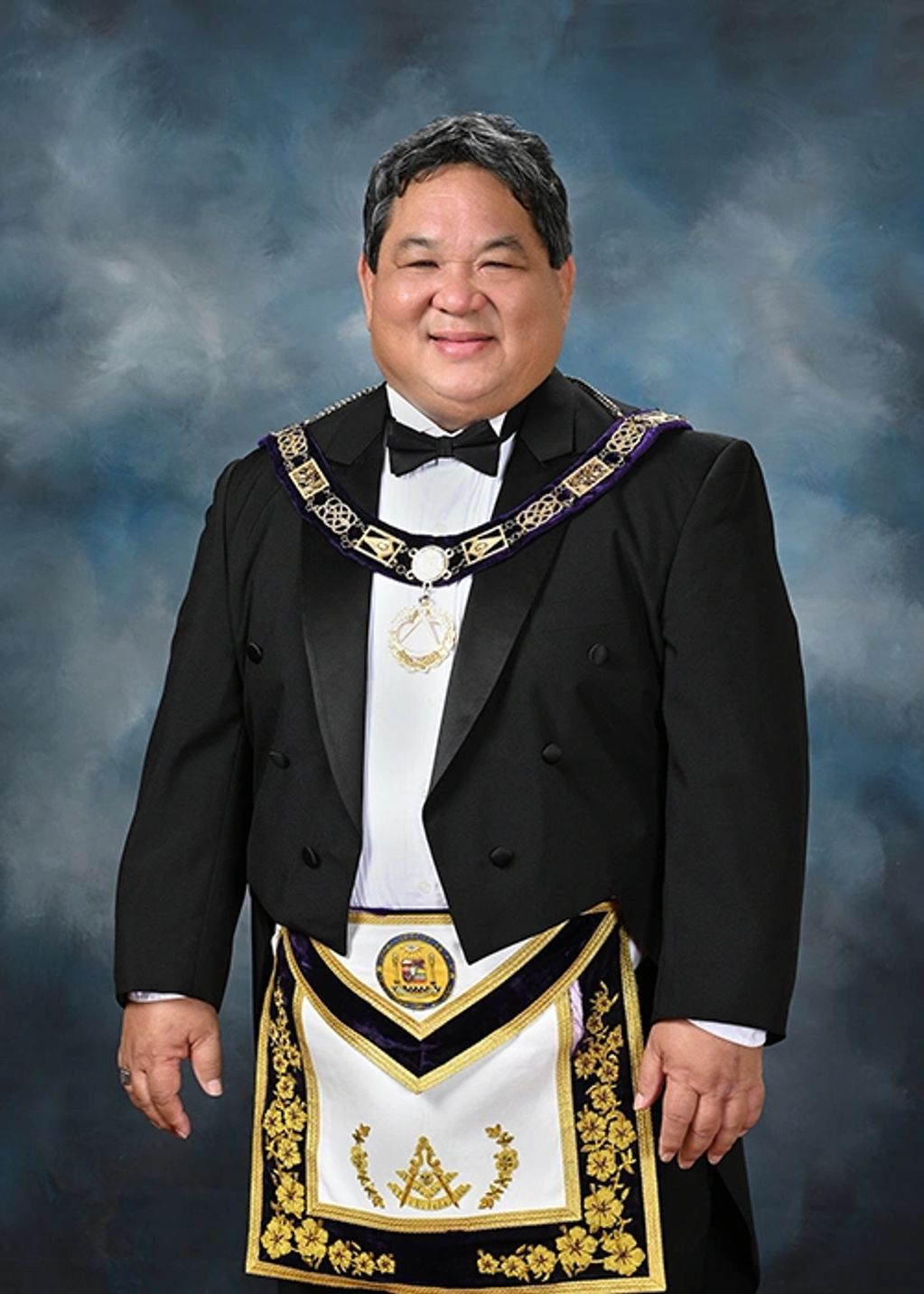 Man in formal Masonic regalia with apron and collar.