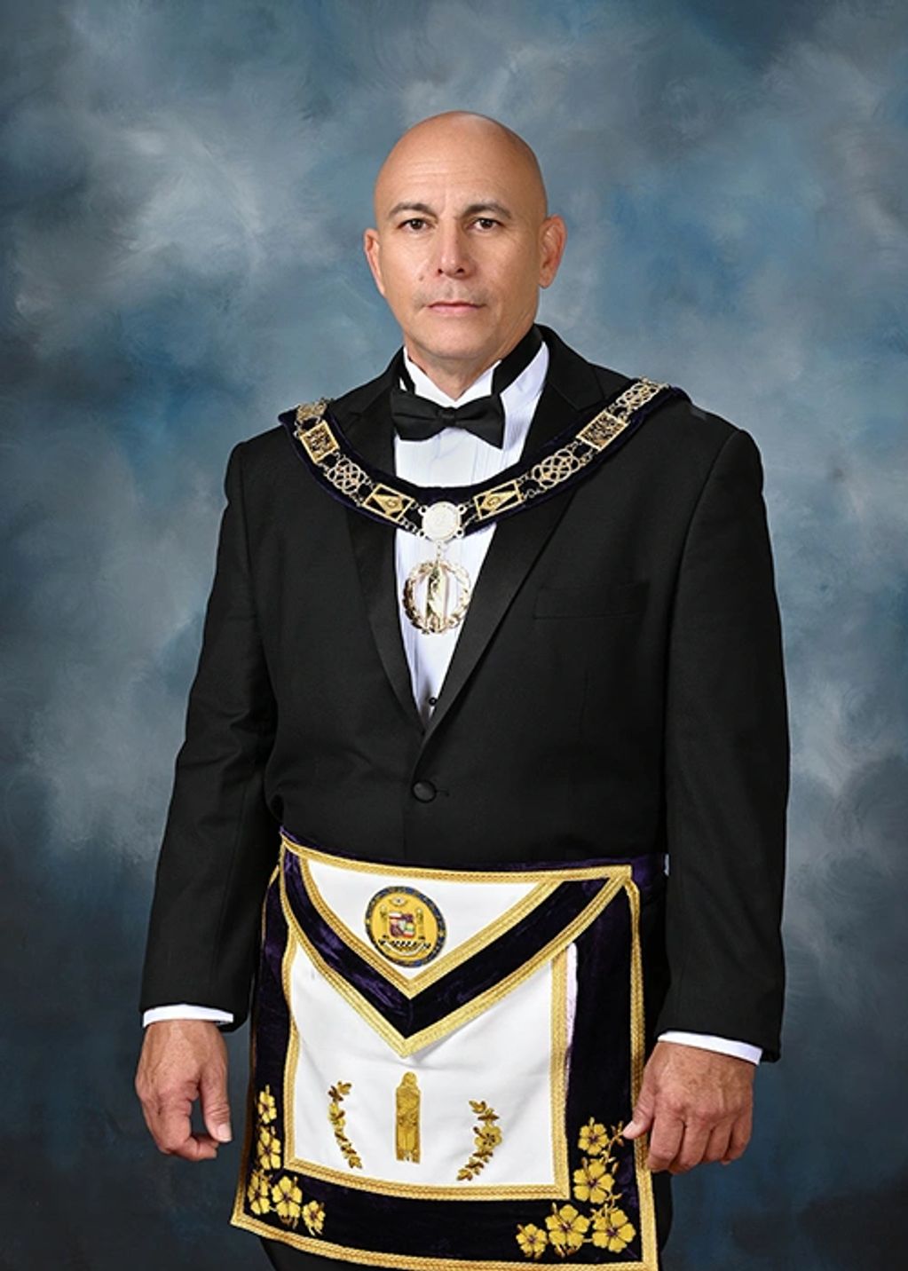 Man dressed in formal Masonic regalia including apron and collar.