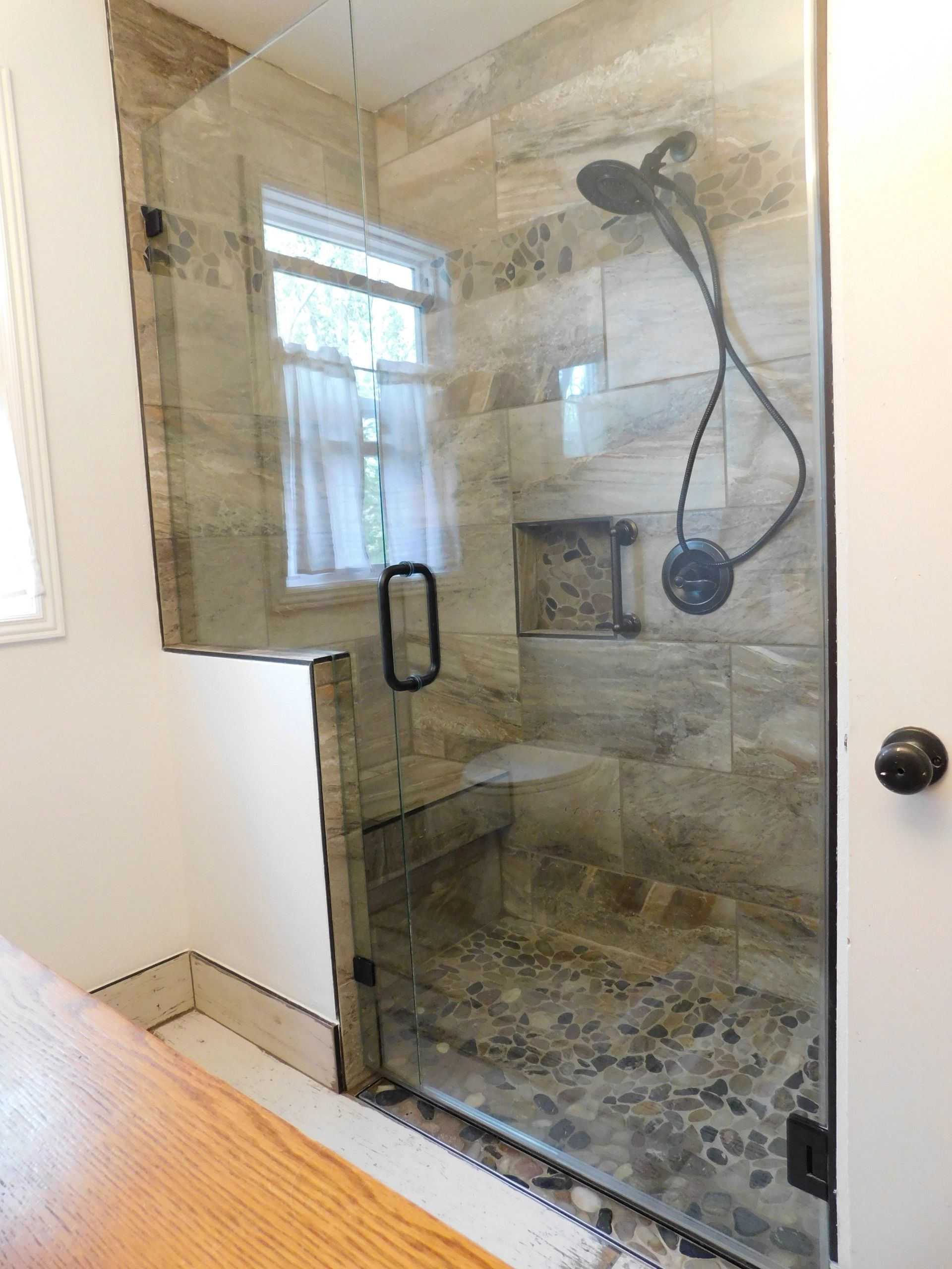 Bathtub/shower changed into a walk in shower with bench.