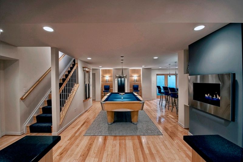 Basement remodel with pool table and wall mounted fireplace electric fireplace.