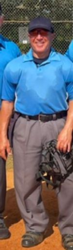 Baseball umpire standing on the field.