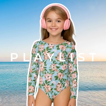 Smiling girl in floral swimsuit with pink headphones at the beach.