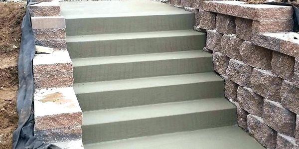 Concrete steps bordered by block retaining walls.