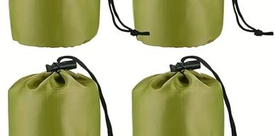 Four green drawstring bags with black cords.