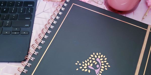 Planner on desk with stationery.