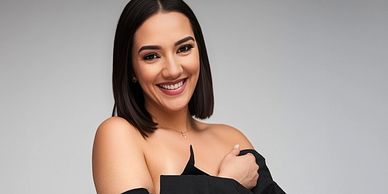 SEO: Studio portrait of a smiling woman in an oversized black shirt, photographed at Click Mode