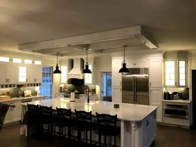 Spacious modern kitchen with large island and pendant lights.