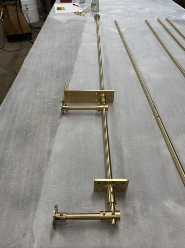 Brass hardware components laid out on a fabric surface.