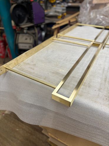 Close-up of brass or gold metal rods and frame.