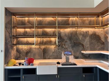 Modern kitchen area with stylish shelving and sink.
