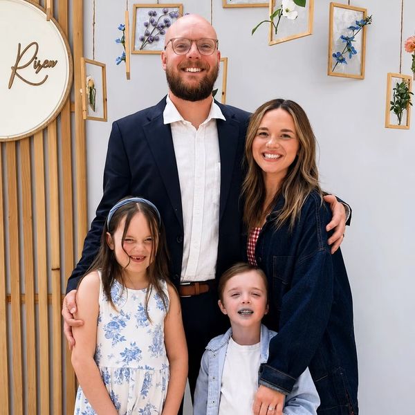 Smiling family of four posing.