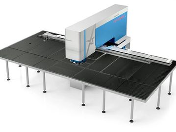 Industrial CNC punching machine with a large black work surface.