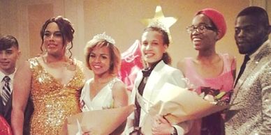 Group of young people dressed for a formal event holding bouquets.