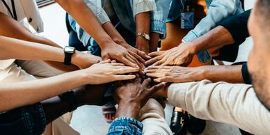 Hands joining in a group showing unity.