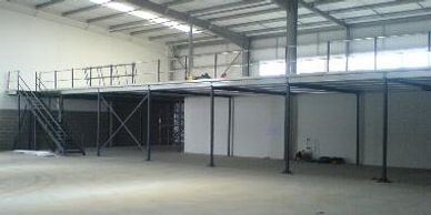 A storage mezzanine floor with access staircase and industrial double tubular handrail in Middlesex.