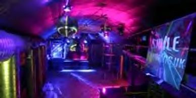 One of Llonssons mezzanine floors  colourfully lit in a nightclub in a railway arch in London.