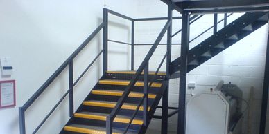 A twin flight steel staircase with quarter turn landing and handrail in Kent. 