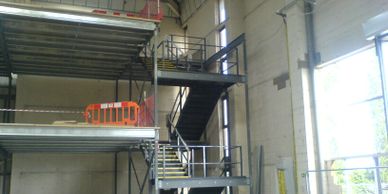 Multi flight staircase with half turn landings serving an office  mezzanine floor near Heathrow. 