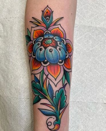Bright and colorful floral tattoo on forearm.