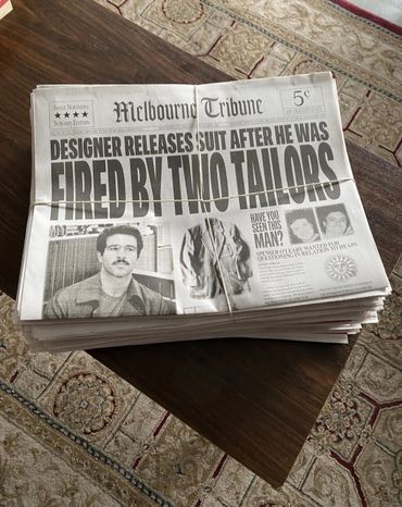 Stack of newspapers titled Melbourne Tribune with headline about designer suing tailors.