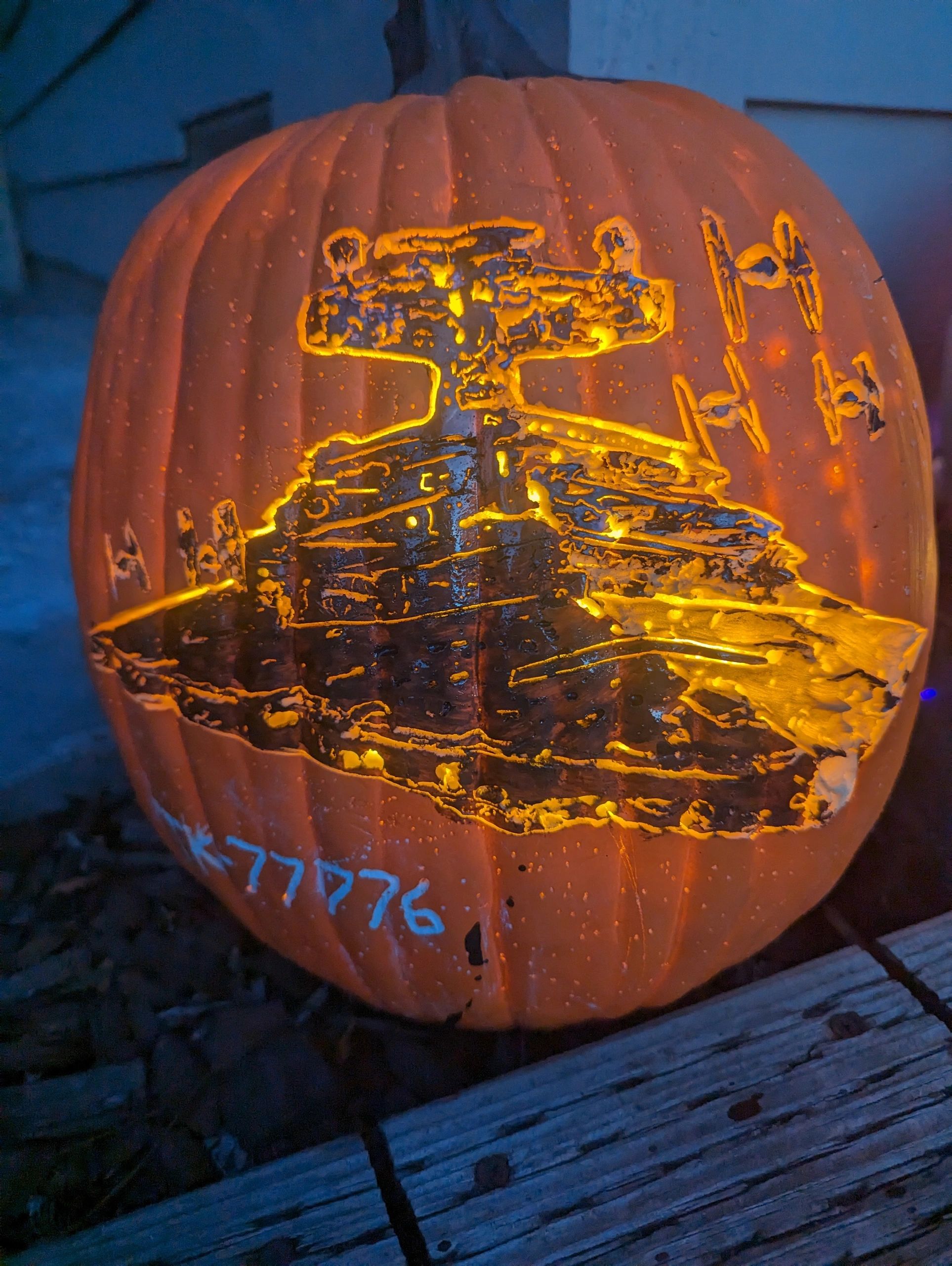 Star Wars-themed pumpkin carving with illuminated spaceships.