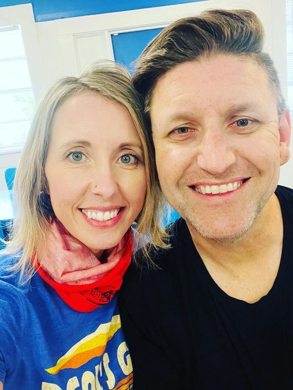 Davis Hart with his wife Heather Hart in a restaurant smiling