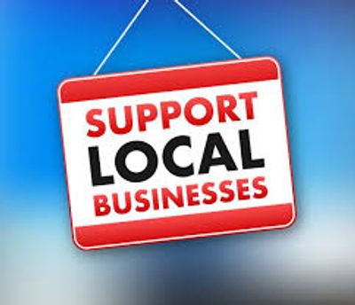 Sign urging support for local businesses with bold red and black text.