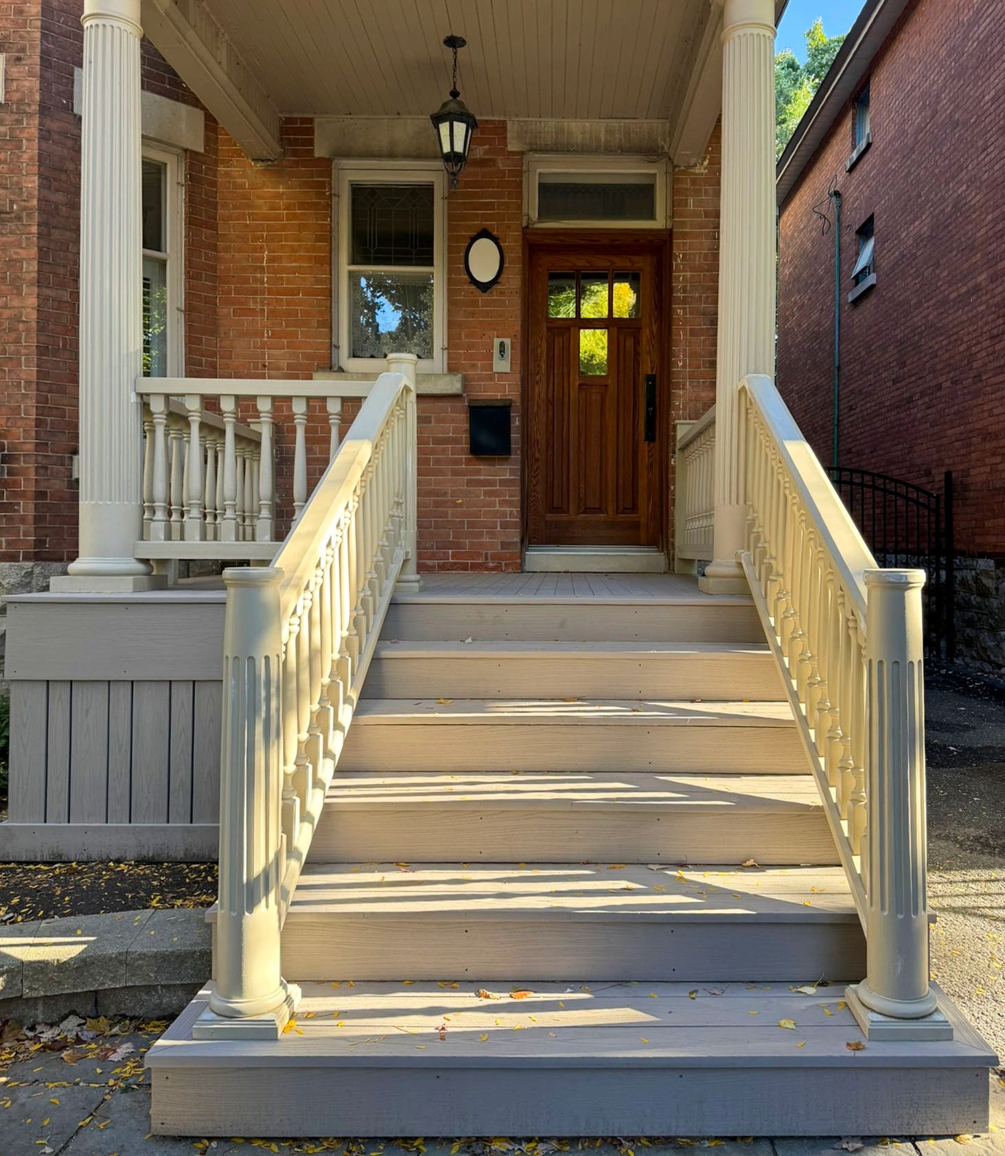 Front porch rebuild in the Glebe with custom turned posts and spindles, new stairs, and PVC decking.
