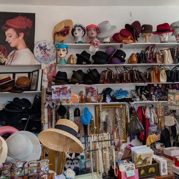 A vintage shop filled with hats, handbags, jewelry, and accessories.