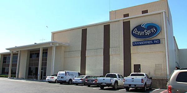 Ocean Spray Cranberries building with parked vehicles.