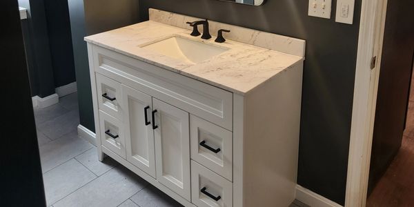 Newly remodeled bathroom showcasing updated fixtures, modern vanity, and stylish tile work