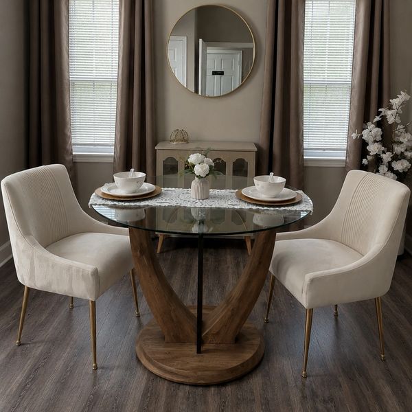 Elegant dining setup with glass table, beige chairs, and soft natural light.